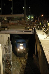 Construction over the tunnel was done at night and coordinated around the train schedule. Noise and vibration were controlled by isolating the tunnel enclosure from the tower structure.