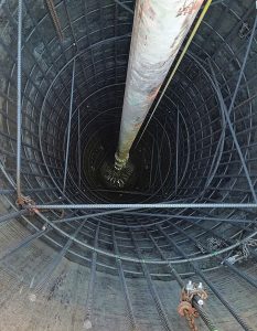 A downhole view of the reinforcing cage and concrete placement for a drilled pier used in the foundation for 1144 Fifteenth Street.