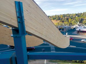 Double curvature glulam beams were seated onto the steel column pedestals using round capital plates to showcase the structural steel column-to-glulam beam connections.