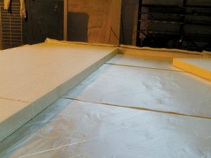 Fiberglass fabric is rolled out into the molding tool in the required direction, and a Fiber-reinforced foam core is placed before vacuum infusion.