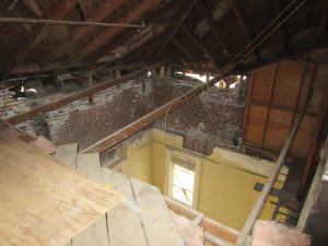 Figure 2. Courtroom view from the attic where brick partially collapsed the ceiling below.