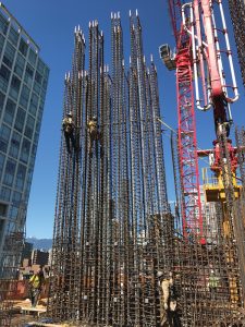 Vertical post-tensioned high-strength DYWIDAG threaded rods in construction.