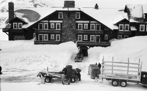 The Many Glacier Hotel in April 1956. Snow has reached the second floor of the lobby. Chimney at left was removed at an unknown date before the recent rehabilitation work. Courtesy of Glacier National Park Archives.
