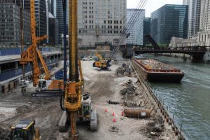 Site looking south. Upper and Lower Wacker Drive to the east (left). The barge moored to the Chicago River Wall provided laydown areas for material storage and a platform to tie reinforcing cages.