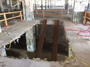 Figure 18. Vehicle access opening cut in the slab during demolition required the installation of shoring posts in the surrounding compromised bays.