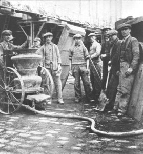 A dry-mix shotcrete (gunite) crew in the 1920s.