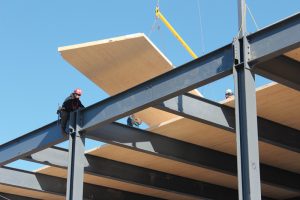 Figure 5. Cross-Laminated Timber (CLT) panels being erected over a structural steel frame.