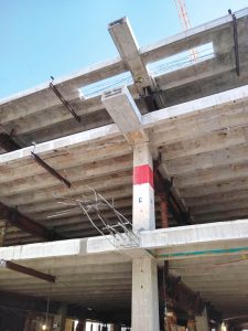 Figure 4. New cantilevered girder ends at various stages of construction, with continuous shoring installed.