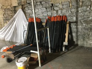 Figure 5. 1½-inch threaded steel bars for micropiles, staged in the basement.