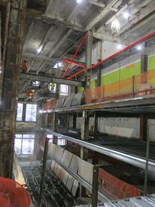 Long room under construction. Shoring in place (highlighted in red) as the long-span deck is installed and existing 4th-floor steel is demolished to create the new atrium.